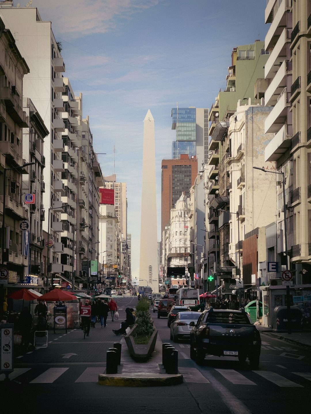 Wide avenue in Buenos Aires with traffic and old buildings