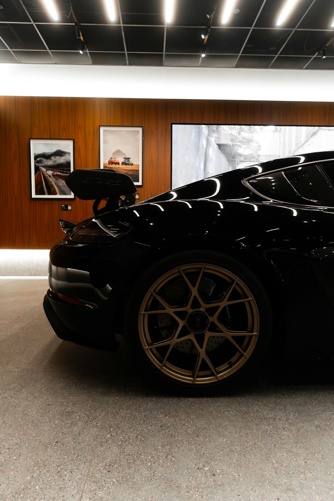Black premium sedan parked in a modern showroom