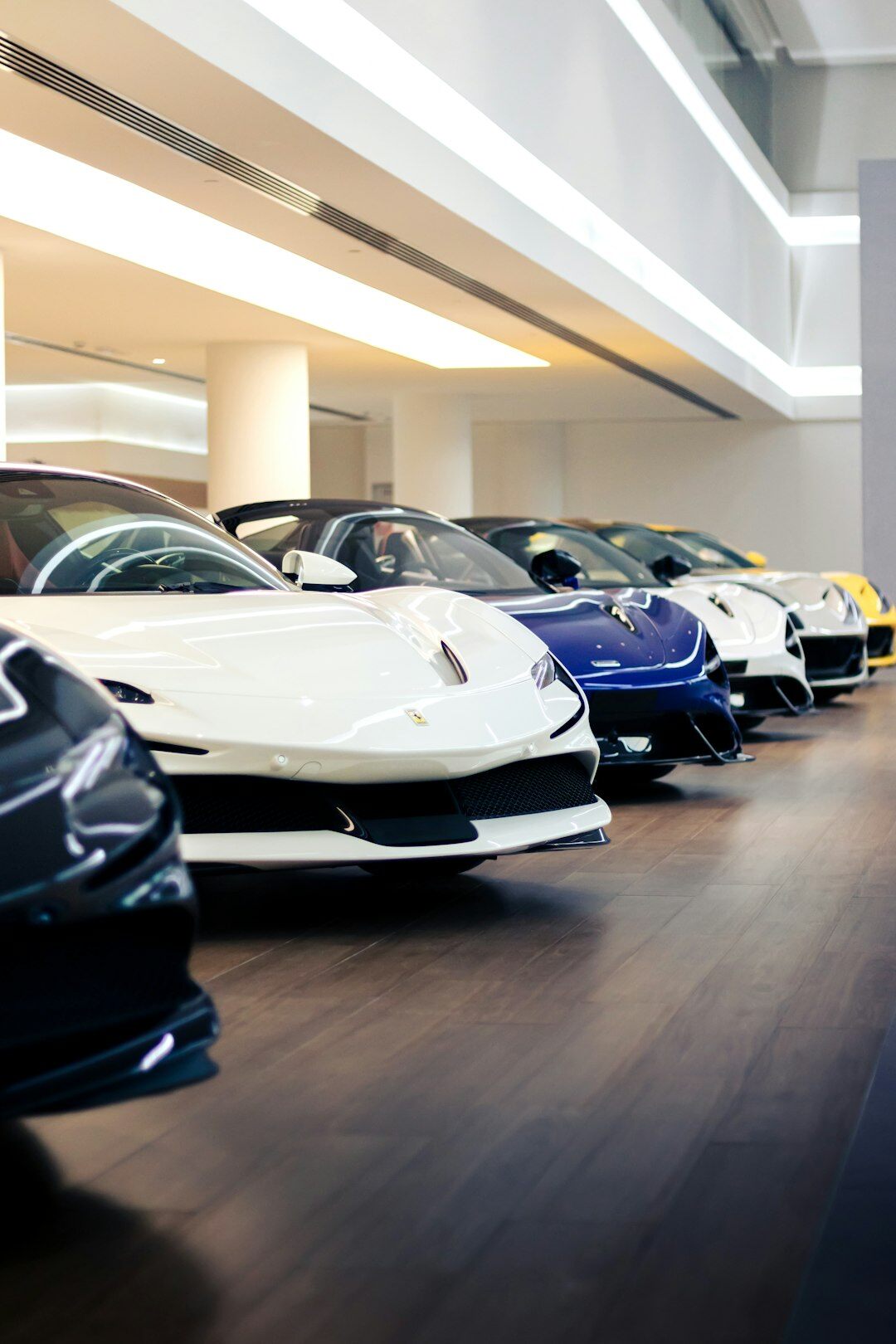 Modern car showroom interior with several premium vehicles