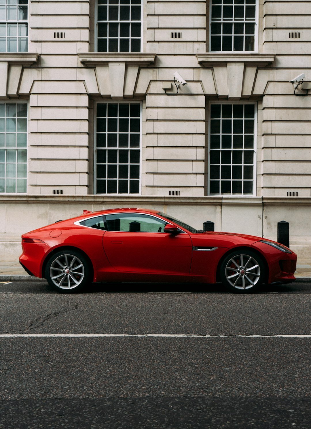 Red sports coupe parked in an underground garage