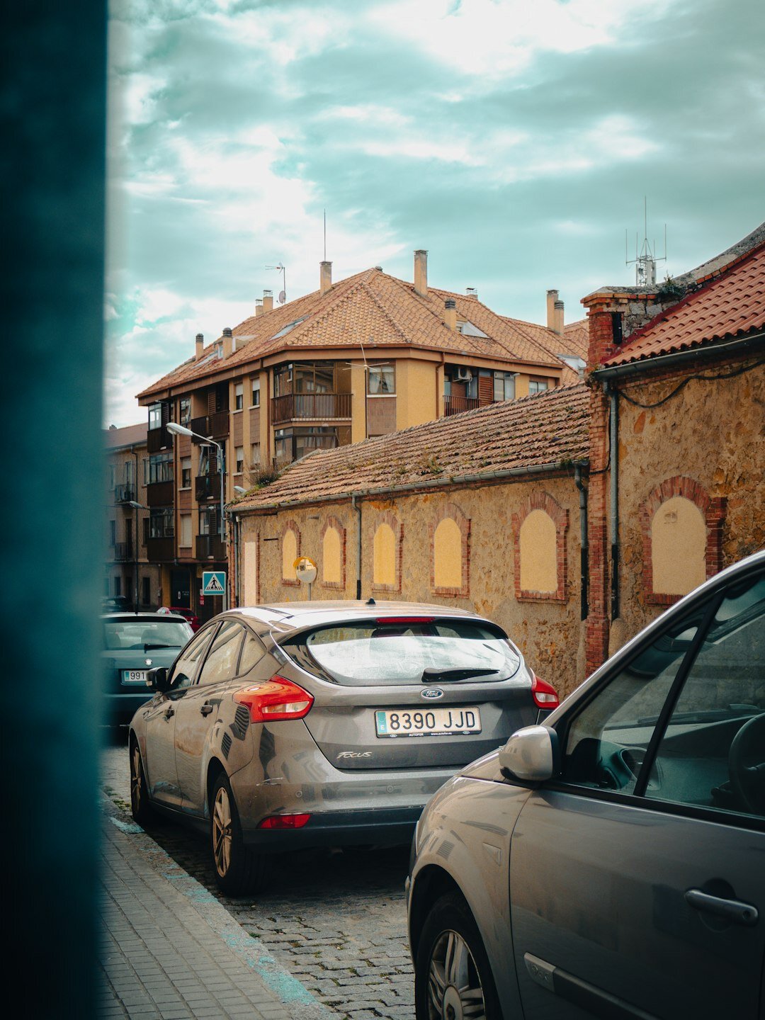 Gray compact hatchback parked on a city street