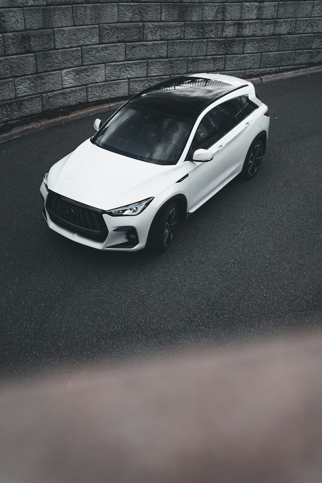 White SUV parked outdoors on a paved driveway