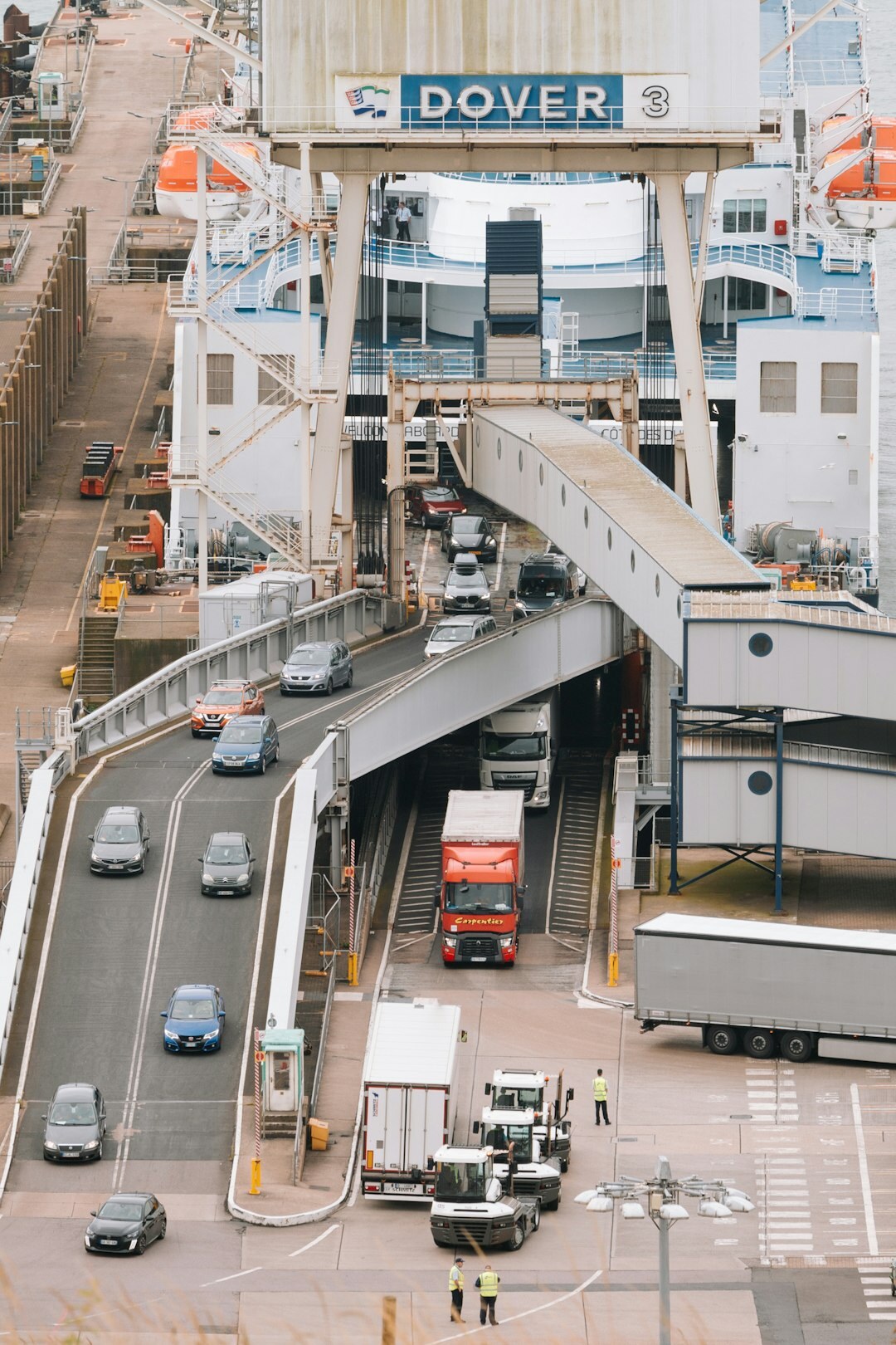 Cars being loaded onto a cargo ship at a port