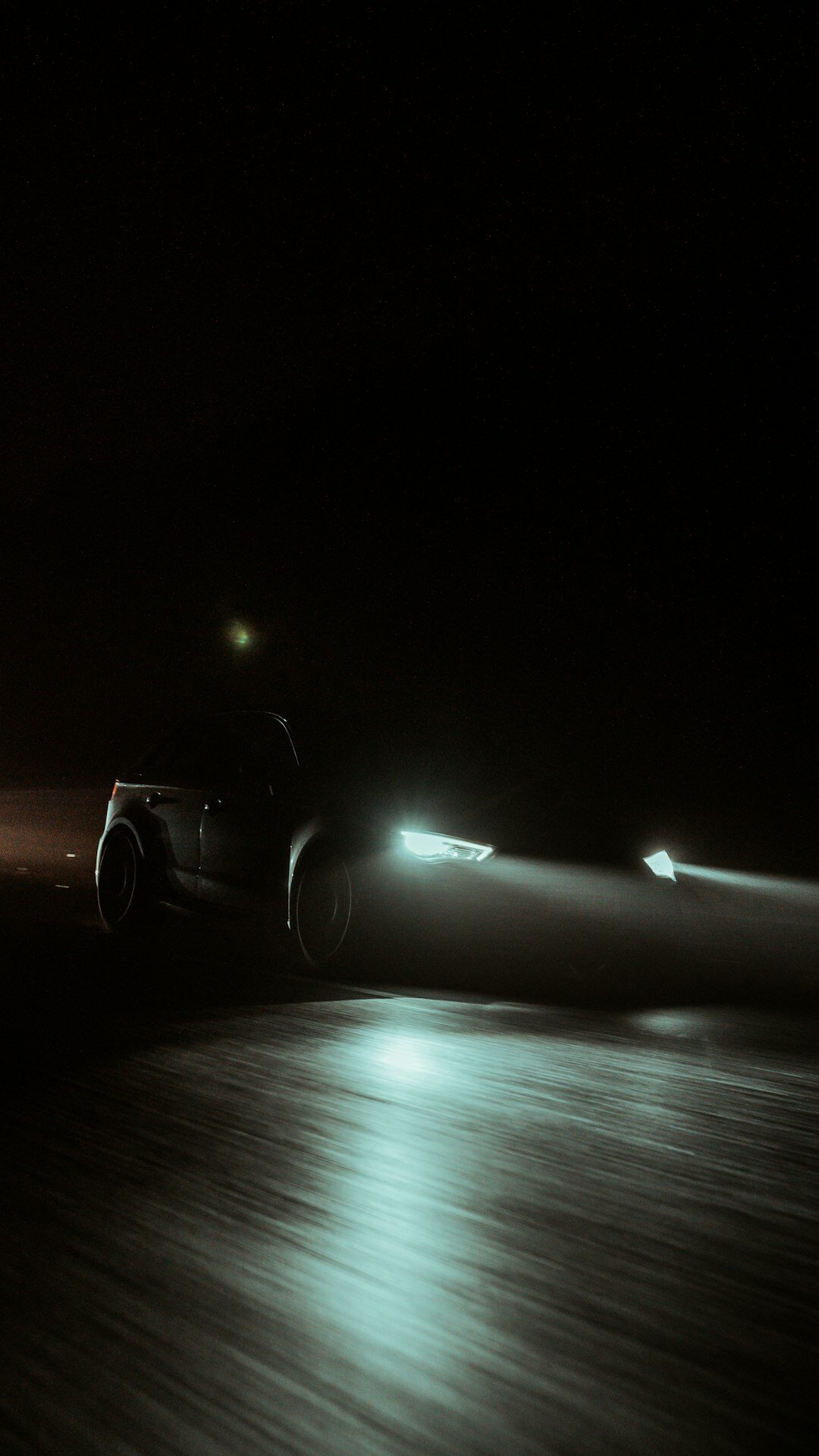 Luxury SUV photographed at night with dramatic lighting