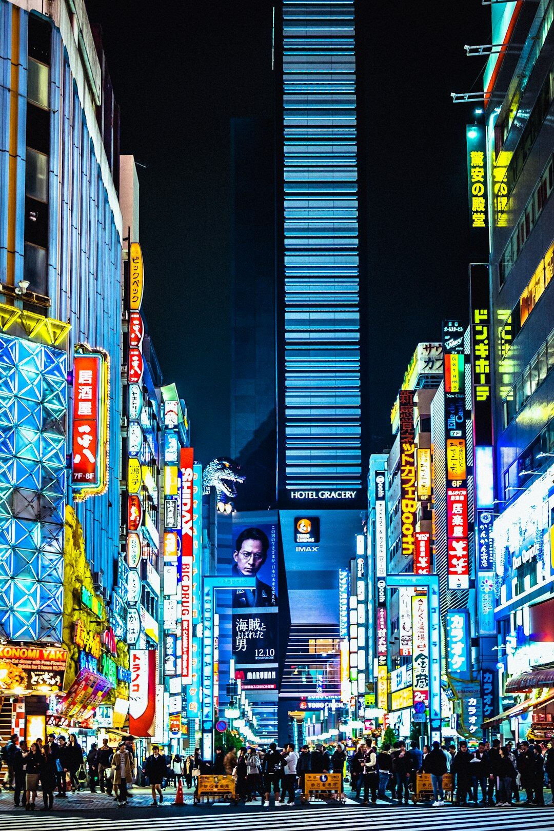 Japanese city street at night with neon lights and cars
